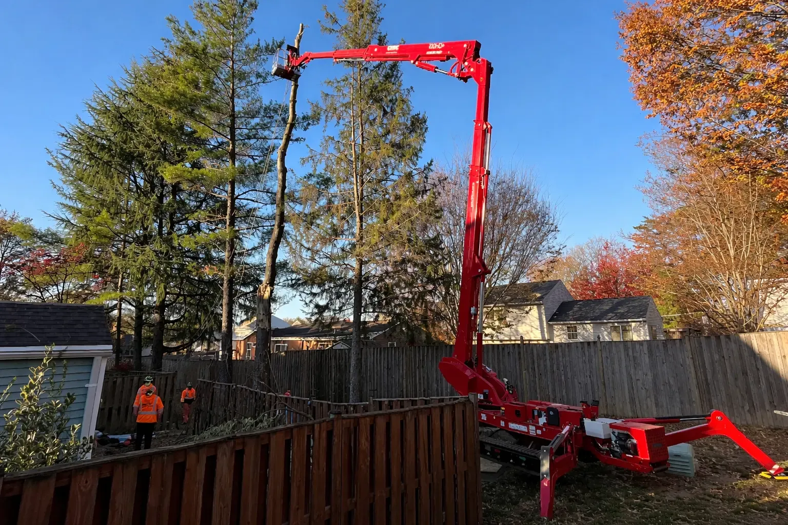 Lift working over a backyard fence